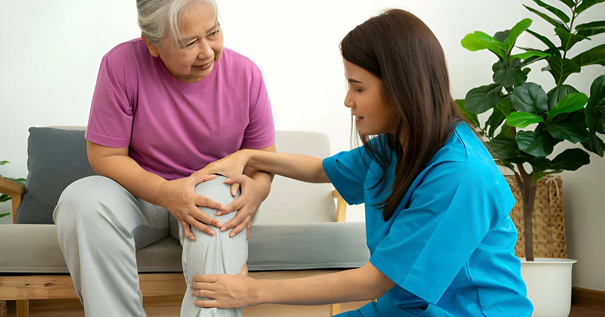 Nurse providing supportive care during knee recovery