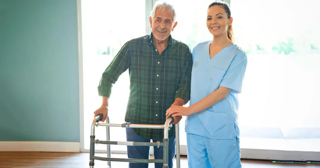 Nurse helps old man walk
