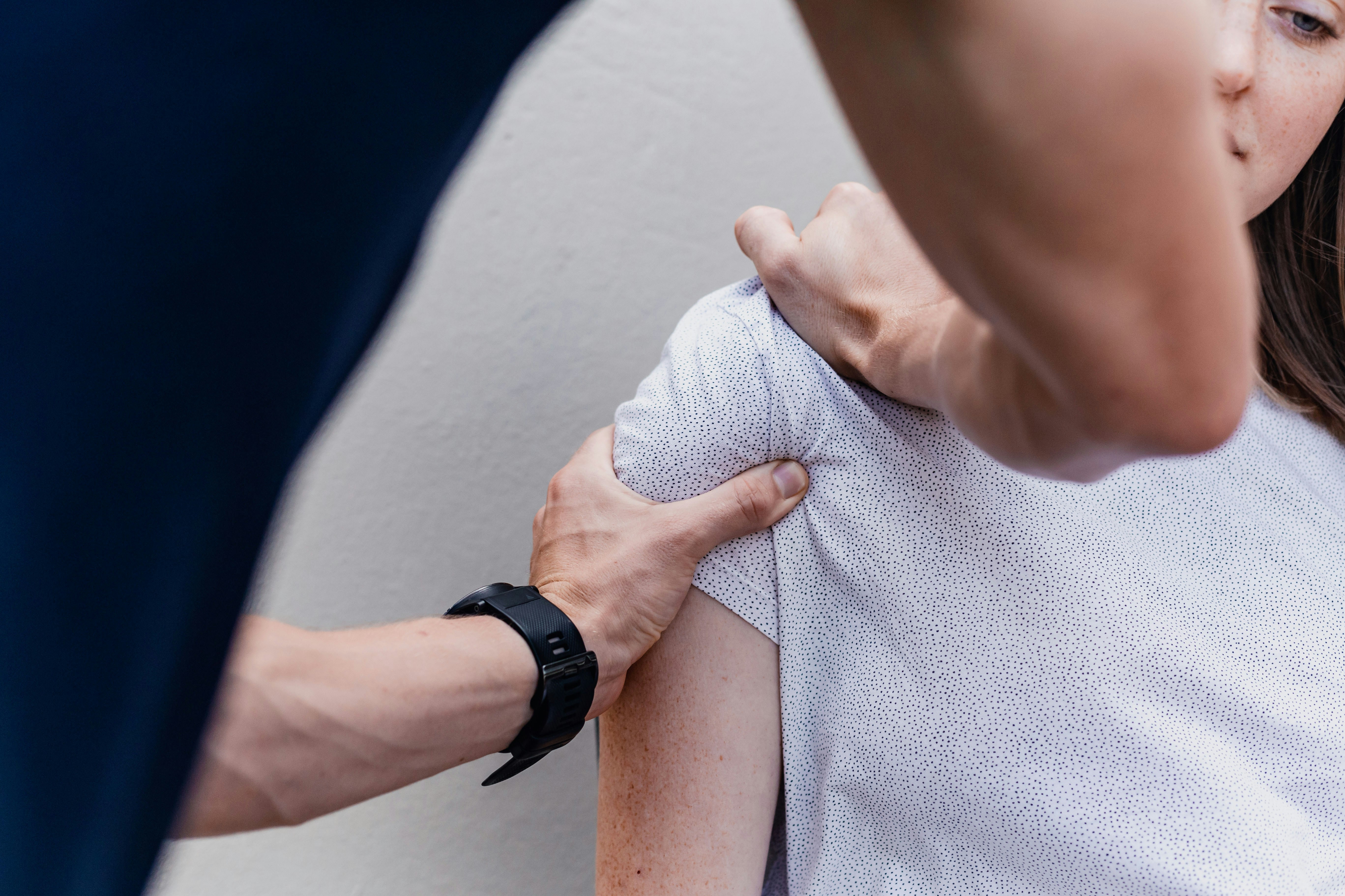 a woman holding onto a mans arm